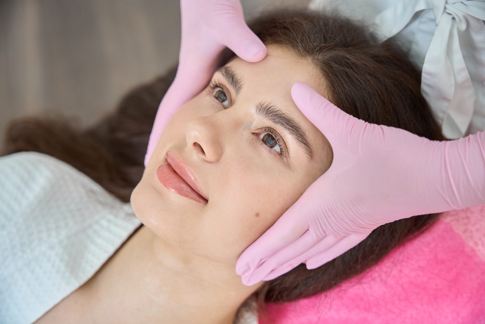 Beauty salon customer is getting facial massage
