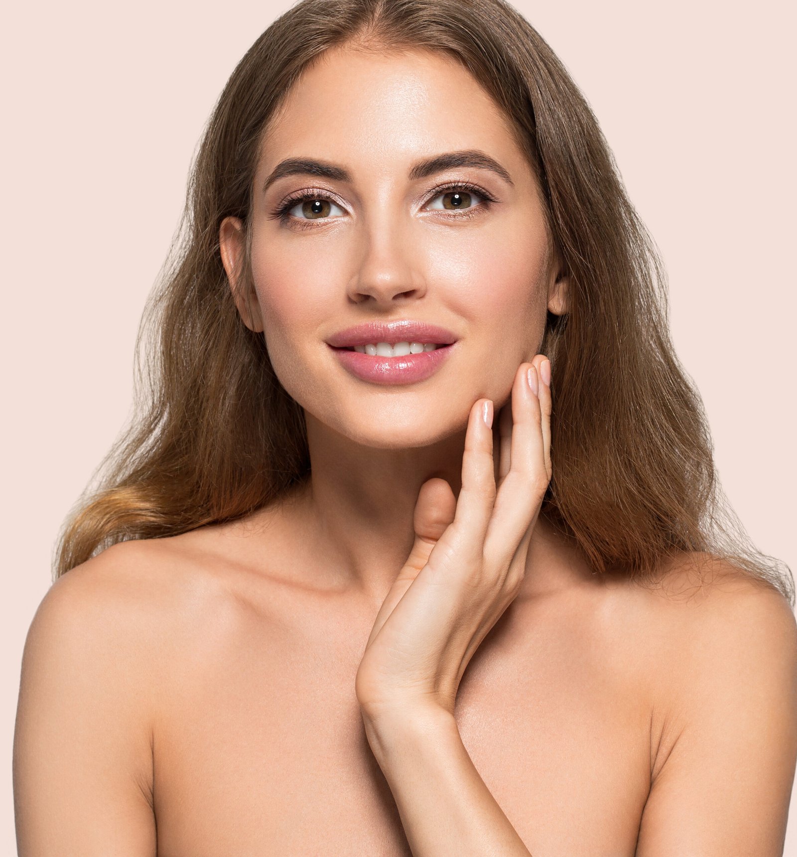 Woman beautiful face healthy. Beauty young model touching herself. Color background. Pink
