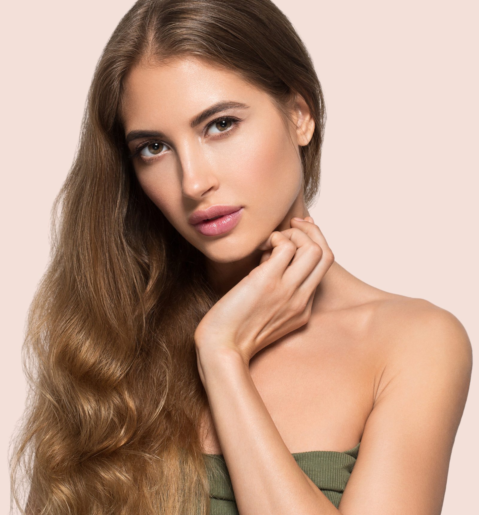 Woman beautiful face healthy. Beauty young model touching herself. Color background. Pink